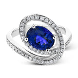 A beautiful 2.04 ct tanzanite center stone anchors this swirling ring, set with .38 ctw of accent diamonds.