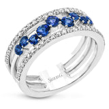 This ring features a meandering path of .65 ctw offset sapphires in it midst, flanked by .38 ctw white diamonds along the edges.