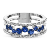 This ring features a meandering path of .65 ctw offset sapphires in it midst, flanked by .38 ctw white diamonds along the edges.