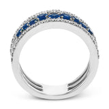 This ring features a meandering path of .65 ctw offset sapphires in it midst, flanked by .38 ctw white diamonds along the edges.