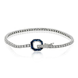 This 18k white gold tennis bracelet features white diamonds along its length, while the octagonal clasp is set with princess cut sapphires to add a vintage touch to the design.