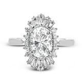 This stunning 18K WG engagement ring is inspired by a ballerinas skirt and features 0.21 ctw RD diam and 0.62 ctw of baguettes, surrounding the center