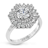 Crafted from 18k gold, this halo ring features a stunning .36 ctw of round diamonds and .49 ctw of baguette shaped diamonds.