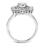 Crafted from 18k gold, this halo ring features a stunning .36 ctw of round diamonds and .49 ctw of baguette shaped diamonds.
