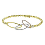 Interlocking ovals crafted in three tones of 18k gold cascade down this fashion pendant, set with .31 ctw of white diamonds.
