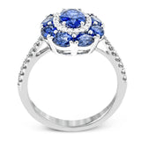 This gemstone ring is the perfect addition to any look, with a 1.52 ct sapphire center stone surrounded my .77 ctw oval sapphires and .21 ctw of white diamonds.