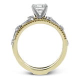 This remarkable set provides the looks of three rings, with a yellow gold ring guard set with yellow diamonds that encompasses the center white gold engagement ring.