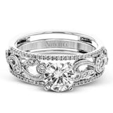 This remarkable set provides the looks of three rings, with a yellow gold ring guard set with yellow diamonds that encompasses the center white gold engagement ring.