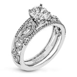 This remarkable set provides the looks of three rings, with a yellow gold ring guard set with yellow diamonds that encompasses the center white gold engagement ring.