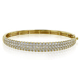 This three-row 18k white gold bangle bracelet is sure to turn heads with 5.42 ctw of white diamonds.