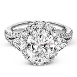 This glamorous white gold ring features 1.01 ctw of round white diamonds and .62 ctw of pear shaped white diamonds as a dazzling backdrop for the center stone