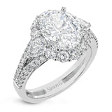 This glamorous white gold ring features 1.01 ctw of round white diamonds and .62 ctw of pear shaped white diamonds as a dazzling backdrop for the center stone