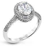 Classic and elegant, this white gold ring sparkles with .40 ctw of round white diamonds framing its oval shaped centerpiece.