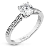 Sleek and lovely, this white gold engagement ring has an elegant design enhanced with .14 ctw of round white diamonds.