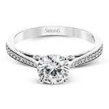 Sleek and lovely, this white gold engagement ring has an elegant design enhanced with .14 ctw of round white diamonds.