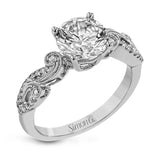The swirling, organic design of this white gold engagement ring features .19 ctw of round white diamonds for added charm.