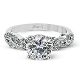 The swirling, organic design of this white gold engagement ring features .19 ctw of round white diamonds for added charm.