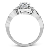 This remarkably beautiful white gold ring features intricate milgrain details alongside a lovely halo of .06 ctw of round white diamonds.