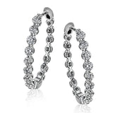 Dazzling yet refined, these white gold hoops showcase an impressive 1.51 ctw of white diamonds