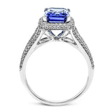 This splendid white gold ring features a delicate split shank and halo, set with .46 ctw of round white diamonds, framing a lovely 2.71 ctw emerald cut tanzanite.