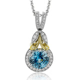 This vintage-inspired white gold pendant features a gorgeous 2.42 ctw blue zircon, complemented by .19 ctw of white diamonds and a yellow gold accent