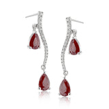 2.07 ctw of elegant ruby teardrops are complemented by .16 ctw of white diamonds in these opulent, glamorous white gold earrings
