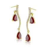 2.07 ctw of elegant ruby teardrops are complemented by .16 ctw of white diamonds in these opulent, glamorous white gold earrings
