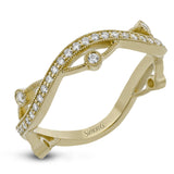 This 18k yellow gold band has a design of in intertwined lines of pave set and bezel set diamonds, which creates a distinctive look.