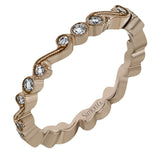 This vintage inspired 18k rose gold ring contains .12 ctw of round white diamonds in a delicate swirling design. Perfect for stacking.