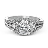 This remarkable white gold ring shows off an oval shaped centerpiece flanked by .47 ctw of trapezoid shaped white diamonds alongside .27 ctw of round white diamonds.
