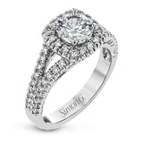 This elegant, contemporary design in white gold sparkles with .45 ctw of round white diamonds in its halo and split shank.