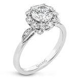 This stunning, contemporary design features .36 ctw of round white diamonds set in its exaggerated halo and delicate side details to evoke a charming floral motif.