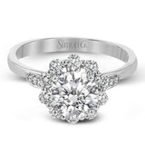 This stunning, contemporary design features .36 ctw of round white diamonds set in its exaggerated halo and delicate side details to evoke a charming floral motif.