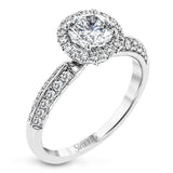 This delicate, vintage-inspired engagement ring sparkles with .42 ctw of round white diamonds in its halo and side details, all set in beautiful white gold.