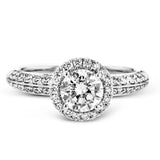 This delicate, vintage-inspired engagement ring sparkles with .42 ctw of round white diamonds in its halo and side details, all set in beautiful white gold.