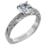 Beautiful in its simplicity, this sleek white gold ring accentuates its centerpiece with delicate engraved details on either side.