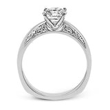 Beautiful in its simplicity, this sleek white gold ring accentuates its centerpiece with delicate engraved details on either side.