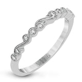 This vintage inspired 18k white gold ring contains .11 ctw of round white diamonds in a delicate swirling design. Perfect for stacking.