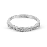 This vintage inspired 18k white gold ring contains .11 ctw of round white diamonds in a delicate swirling design. Perfect for stacking.