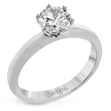 This beautifully simple design in white gold is the perfect setting to let a single round stone shine.