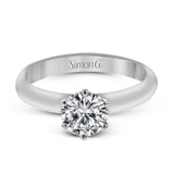 This beautifully simple design in white gold is the perfect setting to let a single round stone shine.