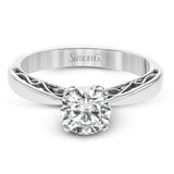 This sleek, elegant white gold ring features delicate filigree detailing to accentuate its single, central stone.