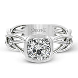 The flowing, organic lines of this contemporary, nature-inspired white gold ring provide a beautifully understated setting for a single, central stone.