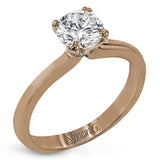 This sleek, unadorned white gold ring provides an elegantly modern setting for a single, central stone.