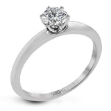 This contemporary, minimalist design in white gold is the perfect way to highlight a single round stone as a centerpiece.