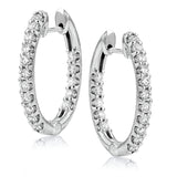 These elegant white gold earrings feature 1.95 ctw of white diamonds