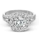This engagement ring has a unique design with a halo of bezel set diamonds. The setting contains .81 ctw of white diamonds.