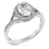 Elegant and sophisticated, this white gold ring's delicate halo and split shank glitter with .28 ctw of round white diamonds to highlight an oval shaped center stone.