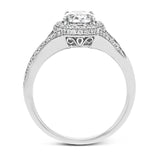 Elegant and sophisticated, this white gold ring's delicate halo and split shank glitter with .28 ctw of round white diamonds to highlight an oval shaped center stone.