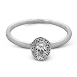This exquisite, minimalist white gold ring features a halo containing .05 ctw of round white diamonds encircling a .17 ctw oval shaped white diamond